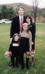 Daughter Patti poses with my grandkids Maris and 
Zoe. Poppa Daryl stands behind them.