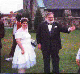 We made it out the door through a shower of Birdseed. Now 
I'm scannining the crowd looking for James.  He's supposed to be 
watching the Loot Bag and driving us to the reception.  Ahh there he 
is.