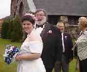 Tina and I barely make it out the door through a 
shower of Birdseed.My Mom and Tinas Dad are talking in the backround