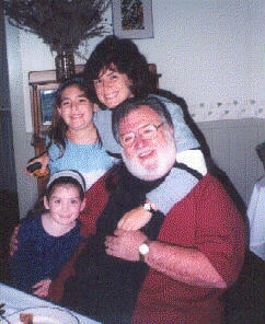 My daughter Patti, her husband an our grand 
children enjoy a hug from granpa Warren during the Pre wedding 
breakfast.